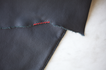 Load image into Gallery viewer, Close-up of hand-stitched red detail on flap of Leather Laptop Sleeve by Soluna Studio